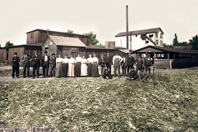 Group of people standing in front of small buildings