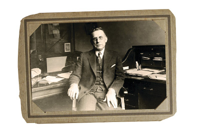 Old-timey picture of a man sitting on a chair