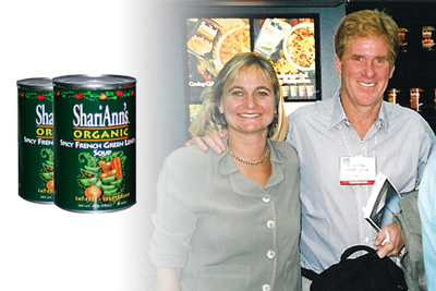Two cans of food overalying a man and woman smiling