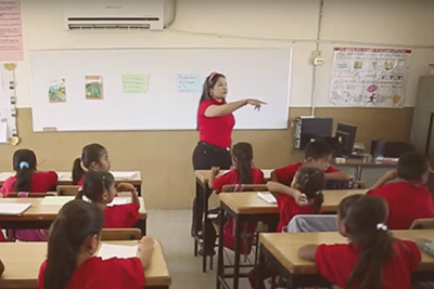 Teacher in front of class of kids